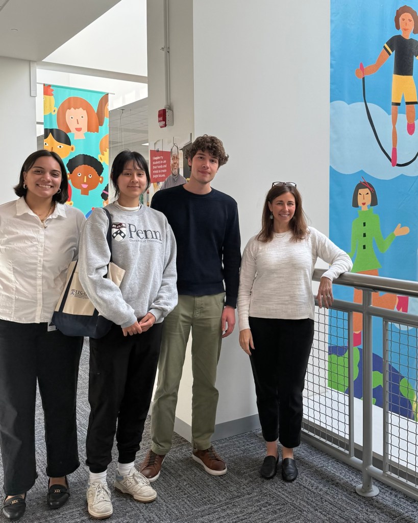 four people standing inside